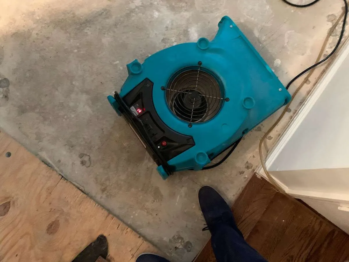Air mover drying subfloor during Commercial Water Damage Restoration in Windham